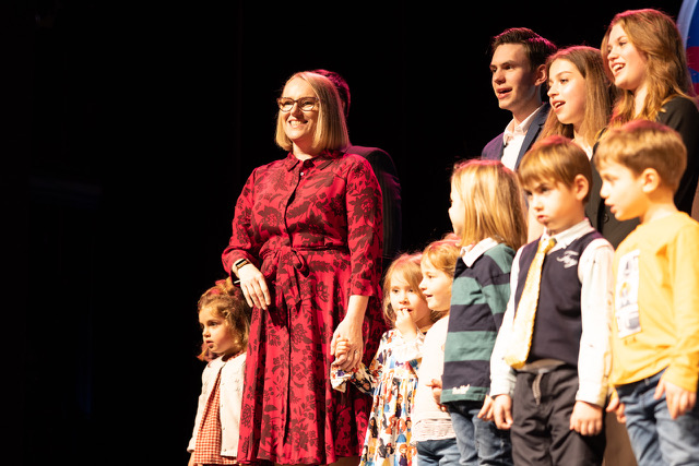 Liz Free welcomes the audience with ISR students from Kindergarten to Grade 12